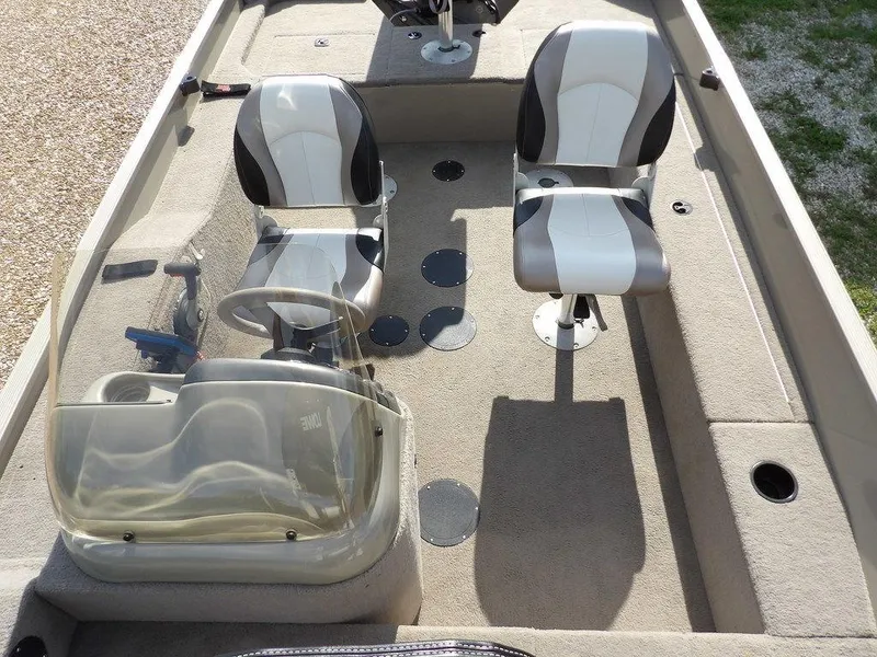 Slide: The Image of 2006 Lowe FM165SC boat interior with two seats and steering console. - 26