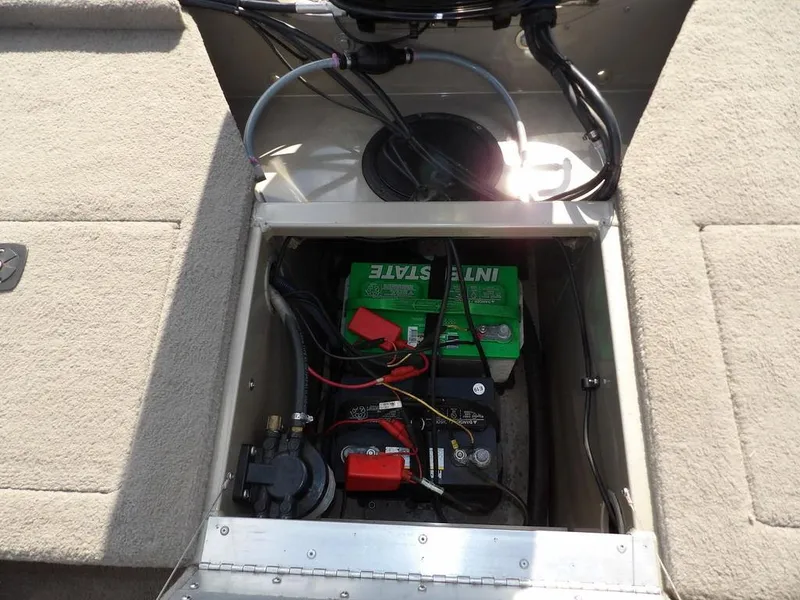 Slide: The Image of Battery compartment of a 2006 Lowe FM165SC boat, featuring Interstate battery and wiring. - 27