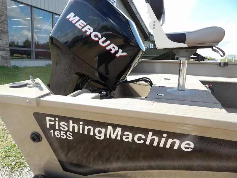 Slide: The Image of 2006 Lowe FM165SC fishing boat with Mercury engine, outdoor setting. - 3