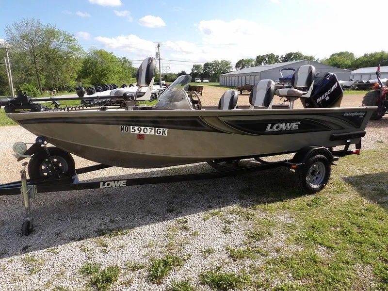 Slide: The Image of 2006 Lowe FM165SC fishing boat on trailer, parked outdoors on gravel. - 35