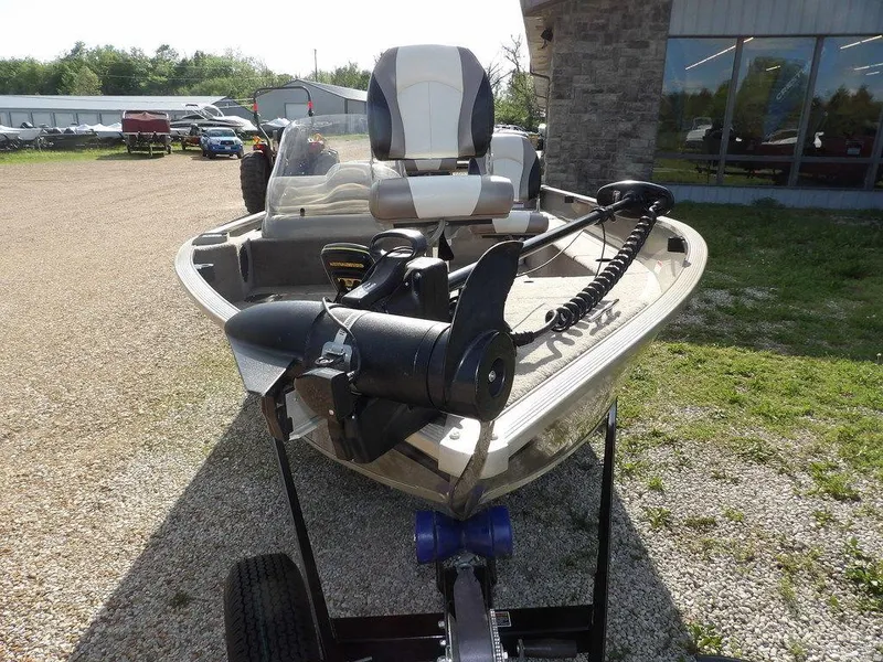 Slide: The Image of 2006 Lowe FM165SC boat on trailer, parked outdoors near a building. - 36