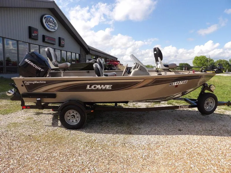 Slide: The Image of 2006 Lowe FM165SC fishing boat on trailer, parked outside dealership under blue sky. - 37