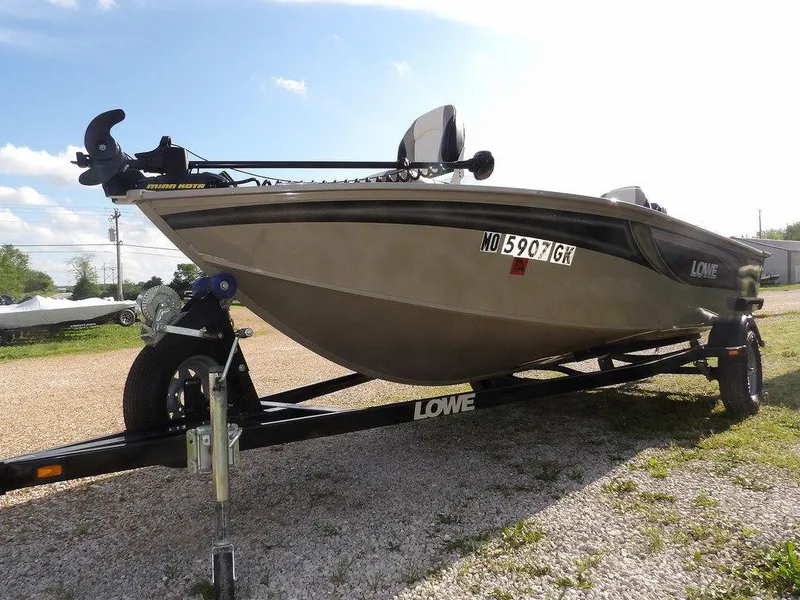 Slide: The Image of 2006 Lowe FM165SC fishing boat on trailer, parked outdoors. - 5