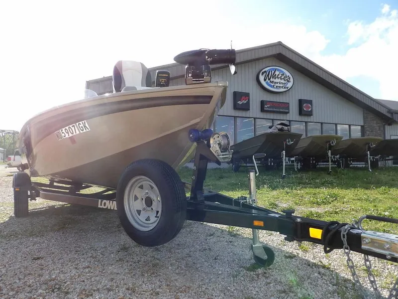 Slide: The Image of 2006 Lowe FM165SC boat on trailer outside dealership, sunny day. - 6