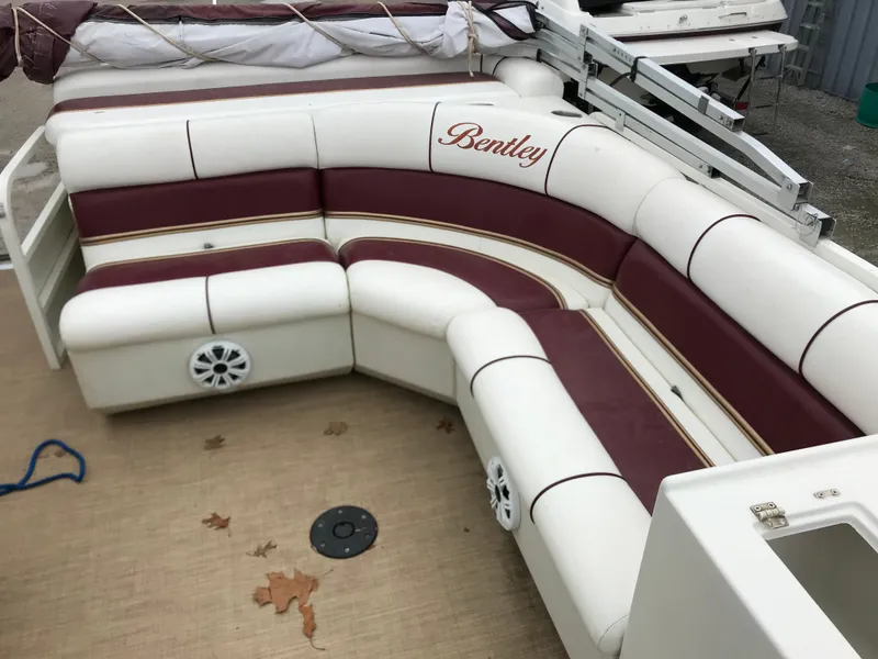 Slide: The Image of 2005 Bentley Pontoons 243 interior with white and maroon seating, featuring branded upholstery. - 15