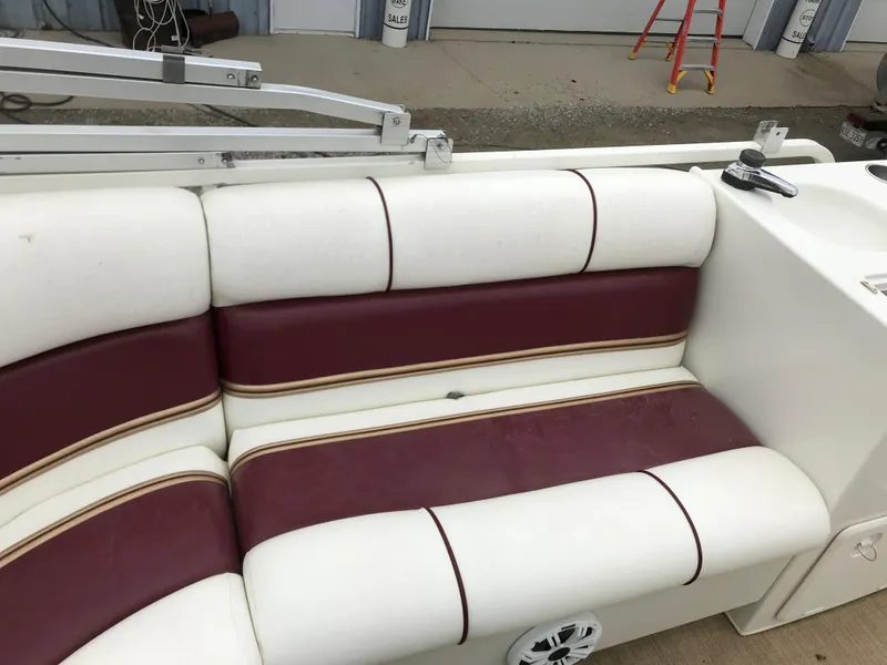 Slide: The Image of 2005 Bentley Pontoons 243 boat interior with white and maroon seating. - 17