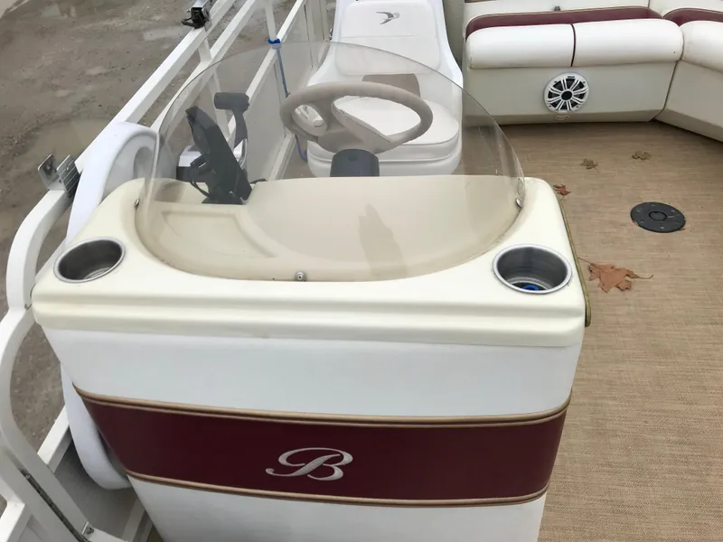 Slide: The Image of 2005 Bentley Pontoons 243 boat interior with steering console and seating area. - 18