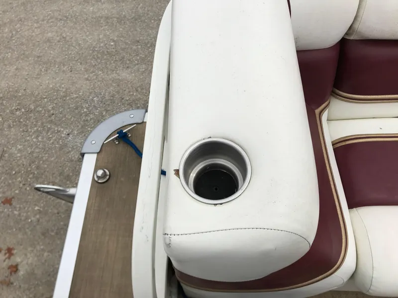 Slide: The Image of 2005 Bentley Pontoons 243 boat seat with cup holder, white and maroon upholstery. - 28