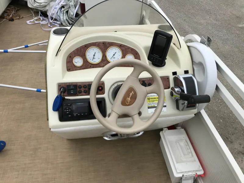 Slide: The Image of 2005 Bentley Pontoons 243 dashboard with steering wheel, gauges, and controls. - 5