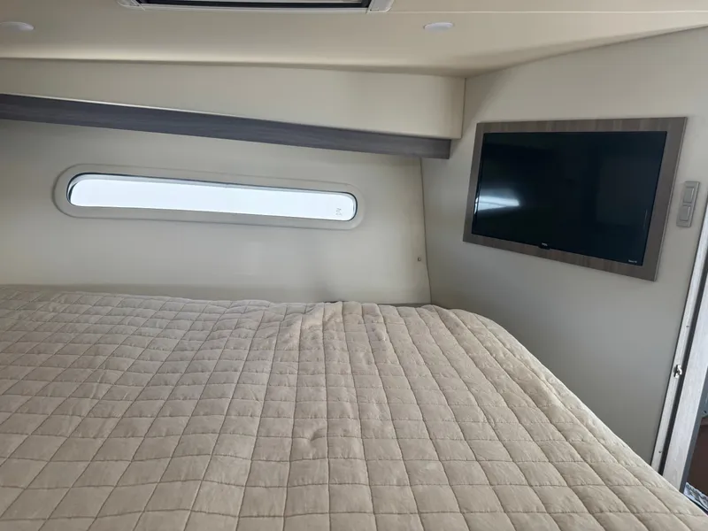 Slide: The Image of Interior of a Regal 38 XO yacht with a bed and TV. - 18