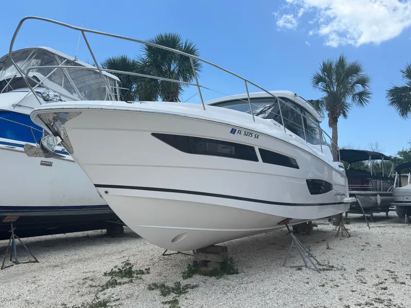 Slide: The Image of A Regal 38 XO boat is on a dry dock, surrounded by palm trees. - 2