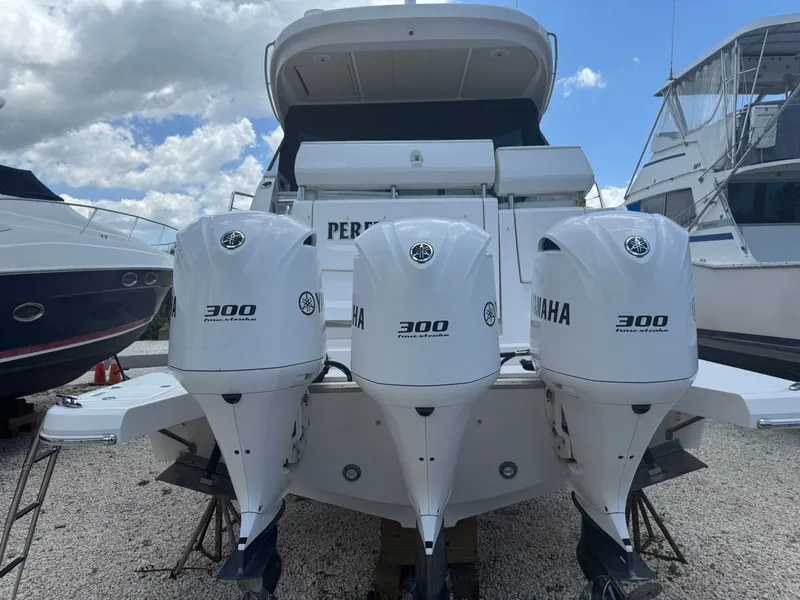 Slide: The Image of Three Yamaha outboard engines on a Regal 38 XO boat in a dry dock. - 3