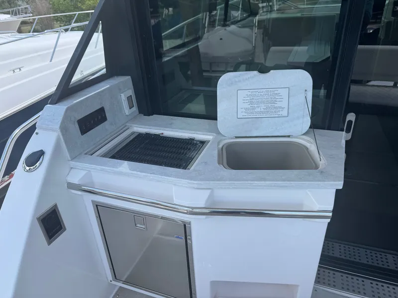 Slide: The Image of A modern boat kitchenette with sink and grill on a Regal 38 XO. - 6