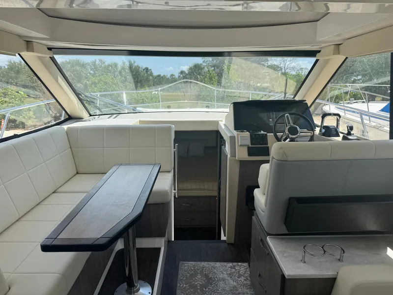 Slide: The Image of Interior of a modern yacht with white seating and a helm station. - 7