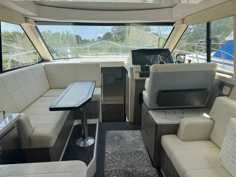 Slide: The Image of Interior of a modern yacht with beige leather seating and a table. - 8
