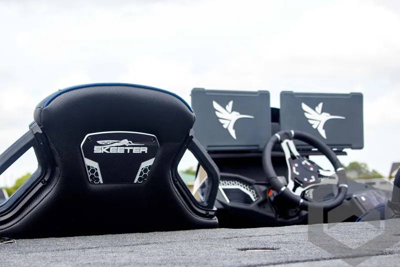 Slide: The Image of 2025 Skeeter FXR 21 Limited boat interior with steering wheel and branded seat. - 11