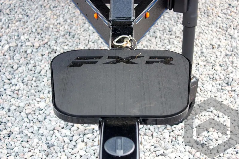 Slide: The Image of 2025 Skeeter FXR 21 Limited trailer step on gravel surface. - 17