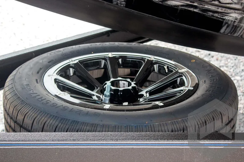 Slide: The Image of 2025 Skeeter FXR 21 Limited trailer wheel with sleek black alloy rim design. - 19