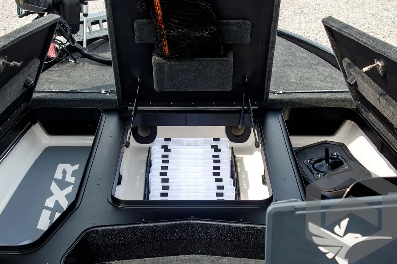 Slide: The Image of 2025 Skeeter FXR 21 Limited boat storage compartments with organized tackle boxes. - 23