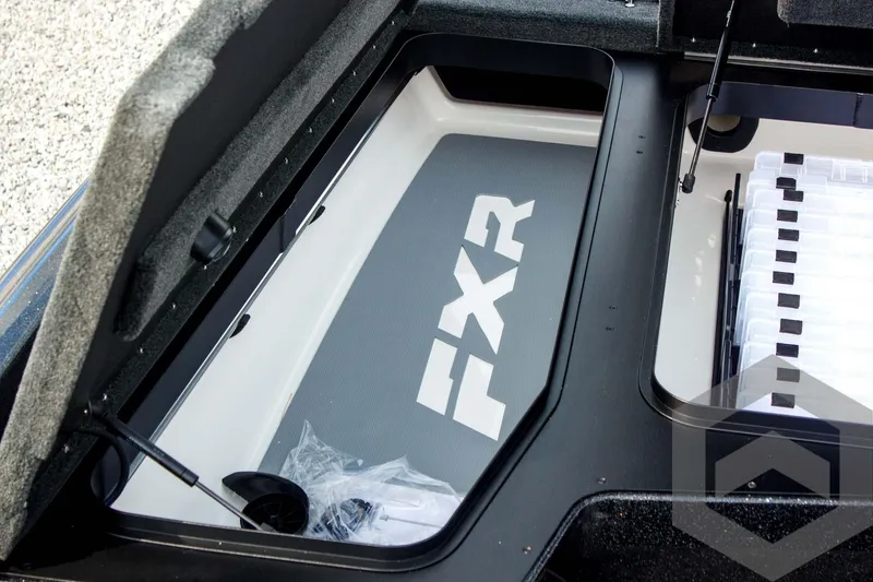 Slide: The Image of 2025 Skeeter FXR 21 Limited boat storage compartment with FXR branding. - 24