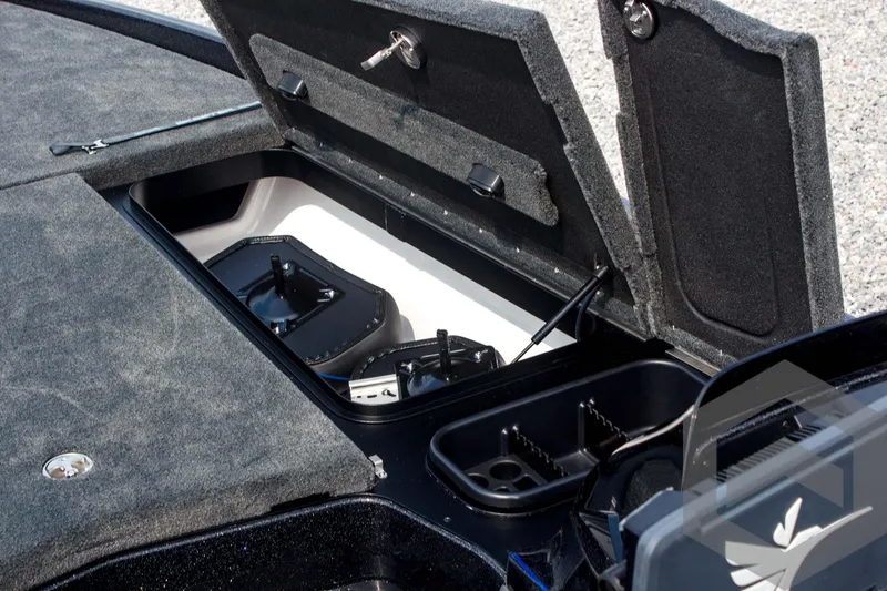 Slide: The Image of 2025 Skeeter FXR 21 Limited boat storage compartments with open lids, showcasing interior features. - 26