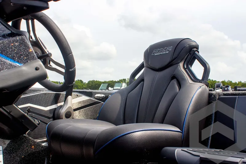 Slide: The Image of 2025 Skeeter FXR 21 Limited boat interior with luxury seating and steering wheel. - 34