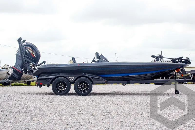 Slide: The Image of 2025 Skeeter FXR 21 Limited boat on trailer, side view, outdoors. - 4
