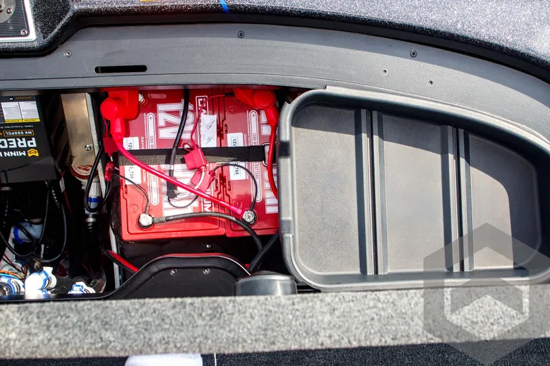 Slide: The Image of Battery compartment of 2025 Skeeter FXR 21 Limited boat, showing wiring and storage. - 45