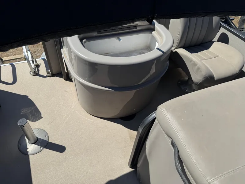 Slide: The Image of 2014 Premier 251 Cast-A-Way boat interior with seating and storage compartment. - 16