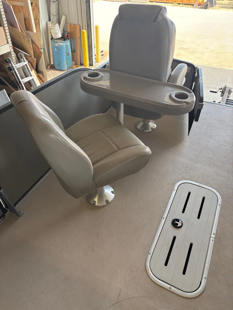 Slide: The Image of 2014 Premier 251 Cast-A-Way boat interior with two seats and a table. - 24