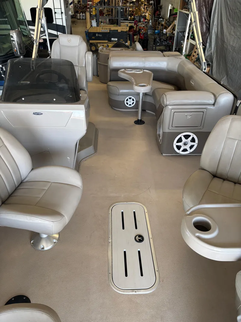 Slide: The Image of 2014 Premier 251 Cast-A-Way boat interior with beige seating and steering console. - 26