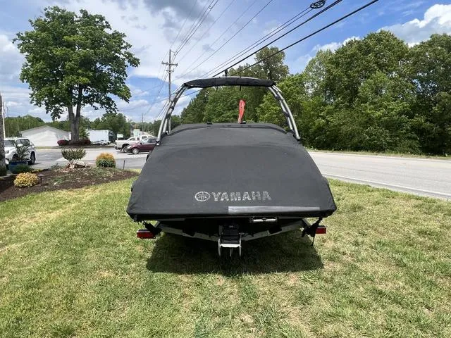 Slide: The Image of 2019 Yamaha AR195 boat with cover, parked on grass near a road. - 8