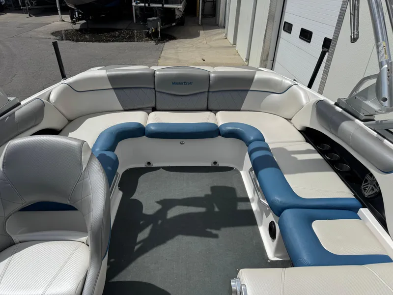Slide: The Image of 2013 MasterCraft X35 boat interior with white and blue seating arrangement. - 4