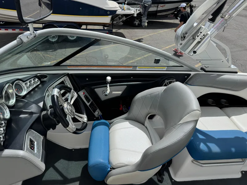 Slide: The Image of 2013 MasterCraft X35 boat interior with steering wheel, dashboard, and seating. - 5