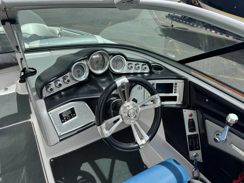 Slide: The Image of 2013 MasterCraft X35 boat dashboard with steering wheel and control panel. - 6