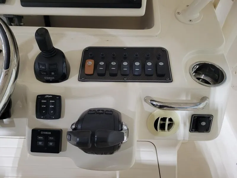 Slide: The Image of Control panel of 2019 Grady-White 336 Canyon boat with Yamaha controls and switches. - 20