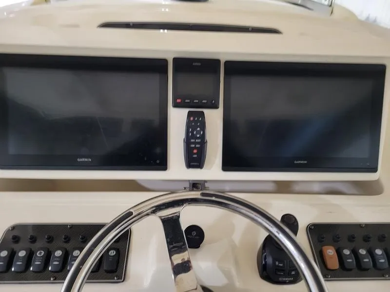 Slide: The Image of Control panel of 2019 Grady-White 336 Canyon boat with dual Garmin displays. - 22