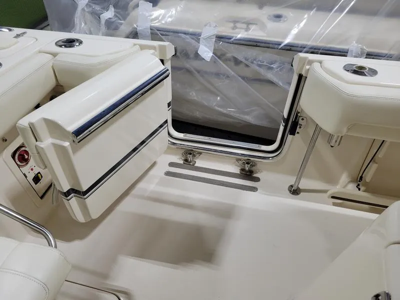Slide: The Image of 2019 Grady-White 336 Canyon boat interior with seating and storage compartments. - 27
