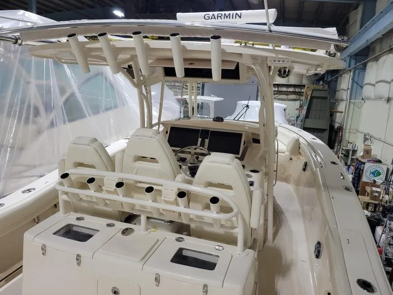 Slide: The Image of 2019 Grady-White 336 Canyon boat interior with Garmin electronics, docked indoors. - 35