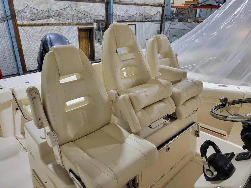 Slide: The Image of 2019 Grady-White 336 Canyon boat with luxurious white seating in a storage facility. - 4