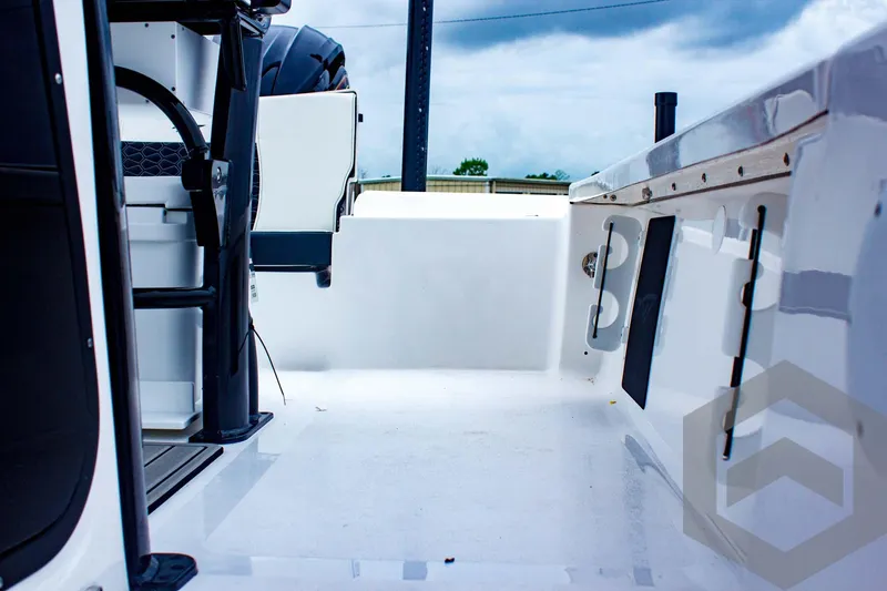 Slide: The Image of 2025 Tidewater 2410 Bay Max boat interior with sleek white deck and modern design. - 27