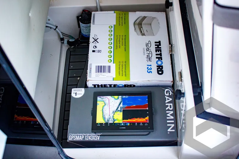Slide: The Image of 2025 Tidewater 2410 Bay Max boat storage with Garmin GPSMAP 1243xsv and Thetford Porta Potti 135. - 29