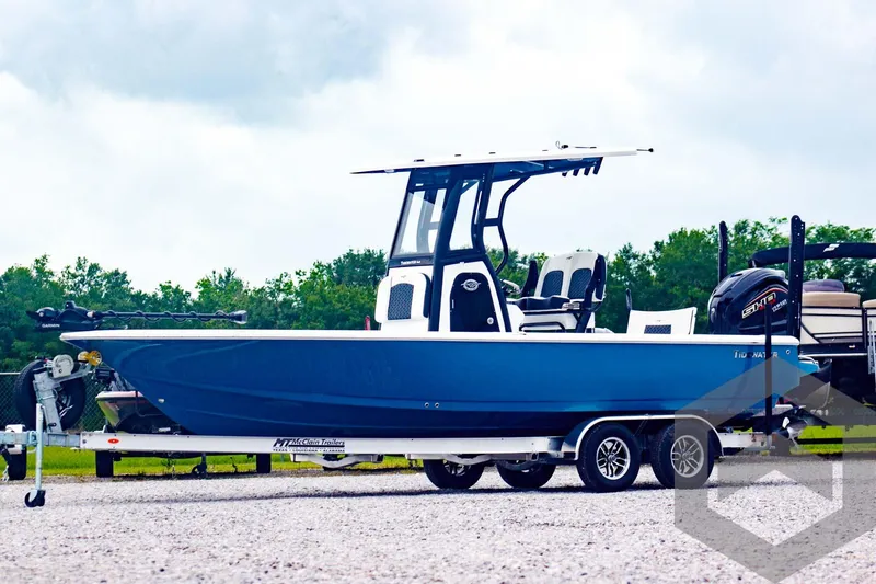Slide: The Image of 2025 Tidewater 2410 Bay Max boat on trailer, blue hull, outdoor setting. - 3