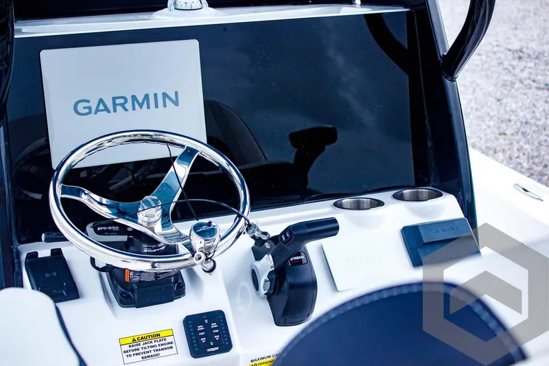 Slide: The Image of 2025 Tidewater 2410 Bay Max boat dashboard with Garmin display and steering wheel. - 33