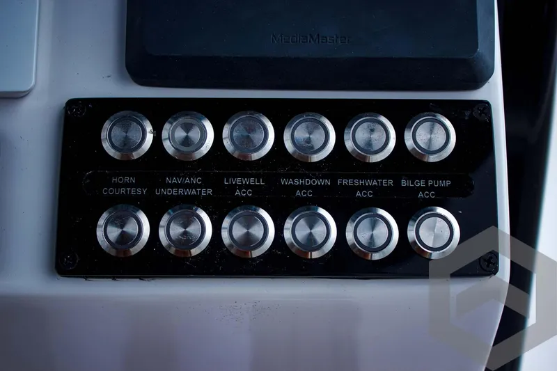 Slide: The Image of Control panel of 2025 Tidewater 2410 Bay Max boat with labeled switches. - 36