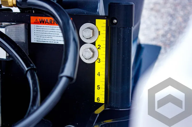 Slide: The Image of Close-up of Tidewater 2410 Bay Max 2025 boat component with measurement scale and warning label. - 42