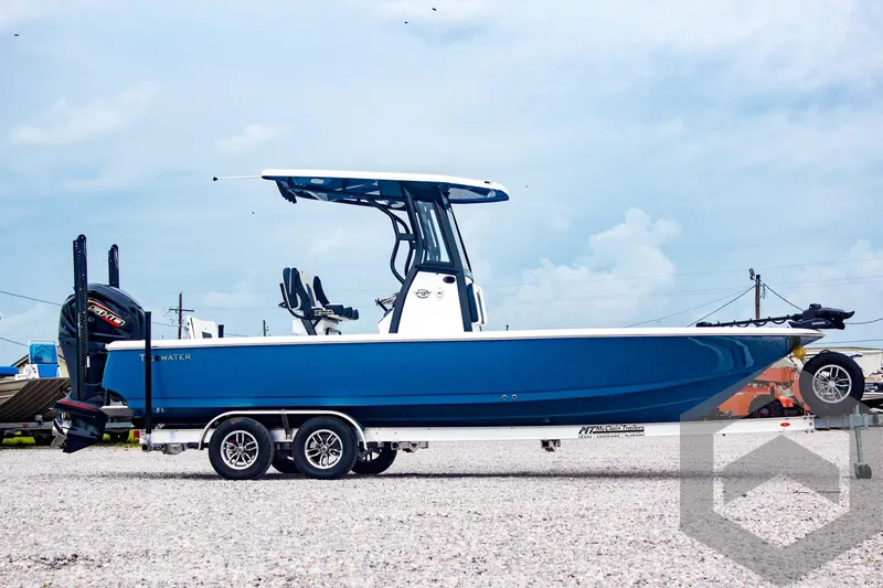 Slide: The Image of 2025 Tidewater 2410 Bay Max boat on trailer, blue hull, outdoor display. - 5