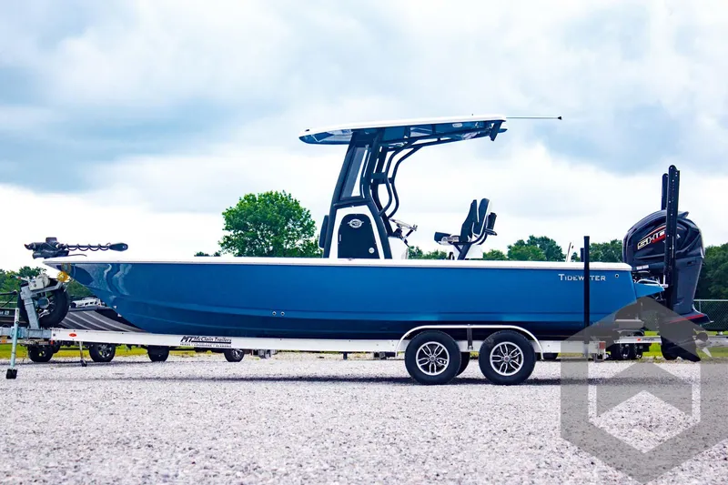 Slide: The Image of 2025 Tidewater 2410 Bay Max boat on trailer, blue hull, outdoor setting. - 9