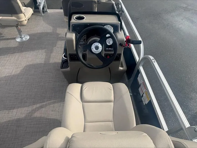 Slide: The Image of 2025 Sun Tracker BB 18 DLX boat interior with steering wheel and seating. - 3