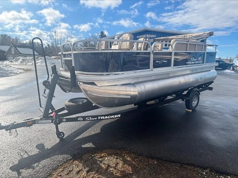 Slide: The Image of 2025 Sun Tracker BB 18 DLX pontoon boat on trailer under clear sky. - 8